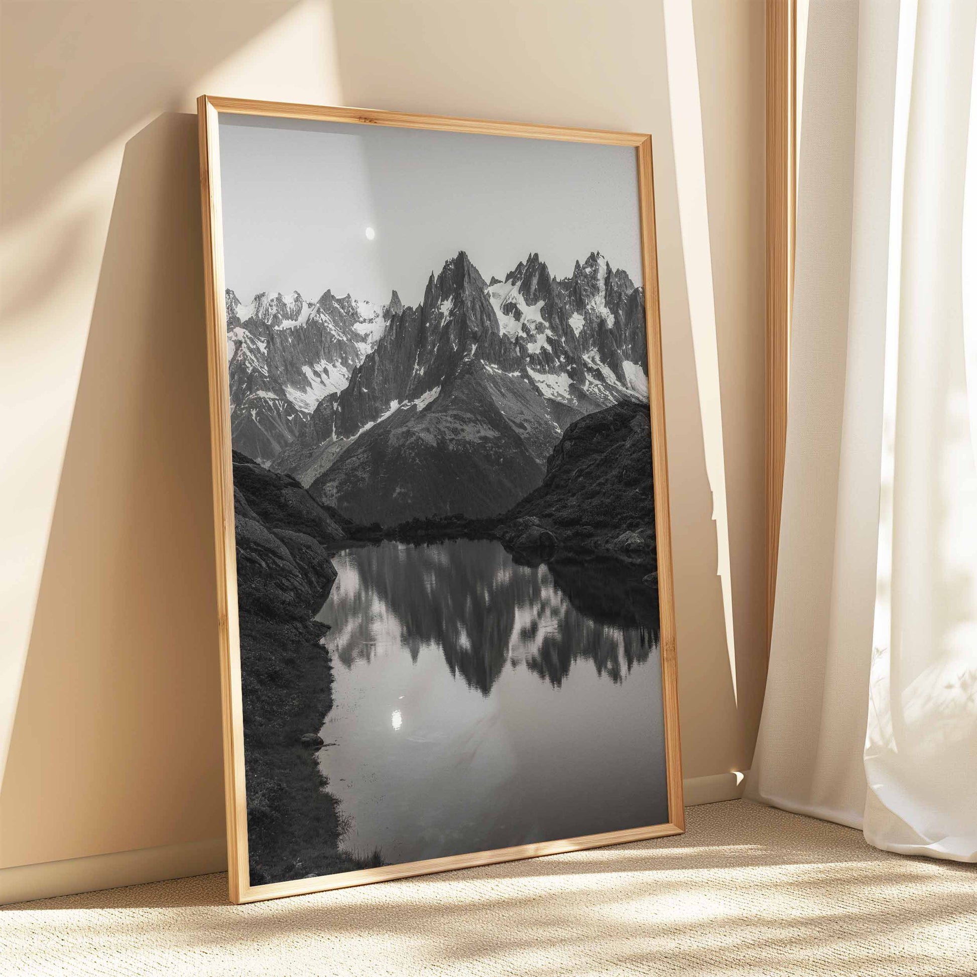 Chamonix’s Lac de la Flégère in black and white, highlighting the contrast of water and rugged peaks.