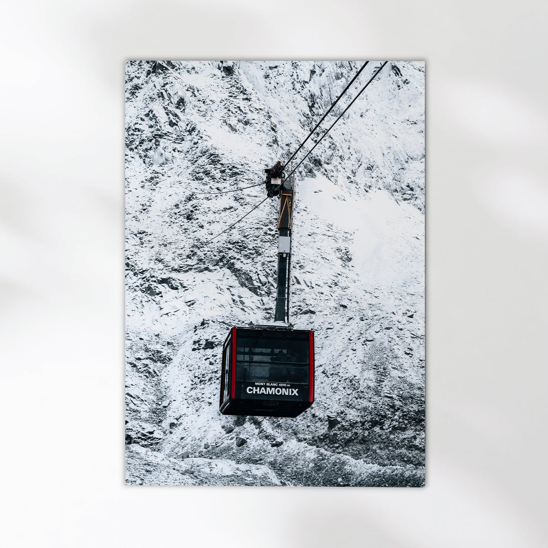 Chamonix cable car suspended above the stunning winter scenery of the French Alps.