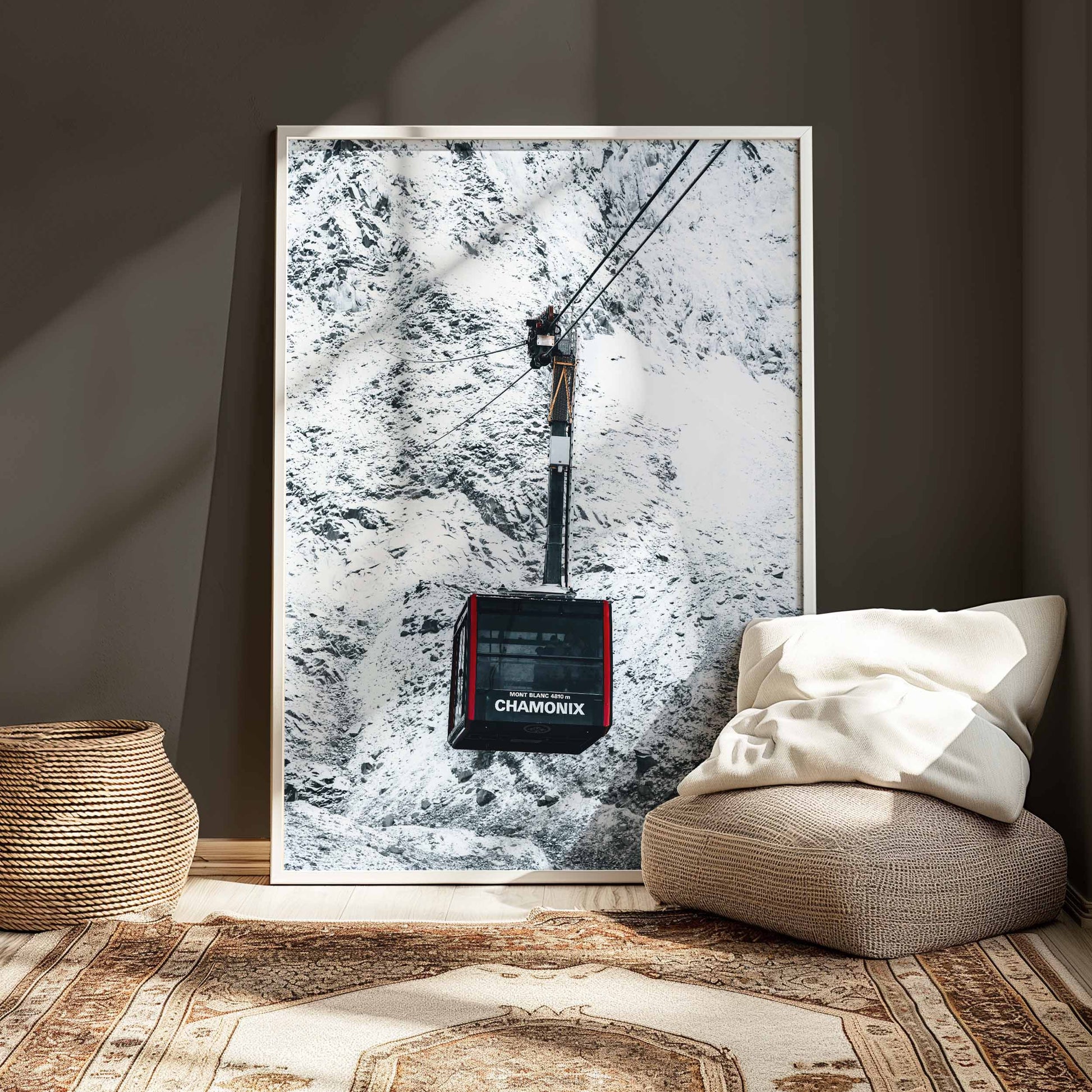  Chamonix cable car wall art framed in white, placed in a cozy, minimalist setting with warm accents.