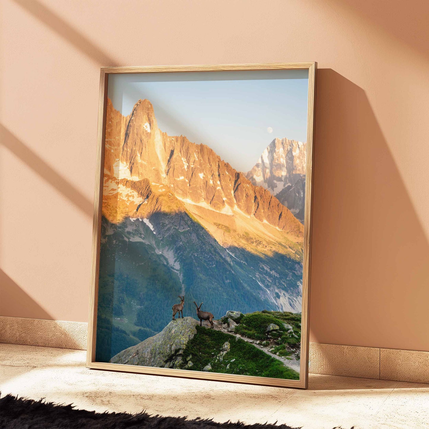 Chamonix ibex print framed in natural wood, capturing golden-hour mountain scenery and ibex on a ridge.