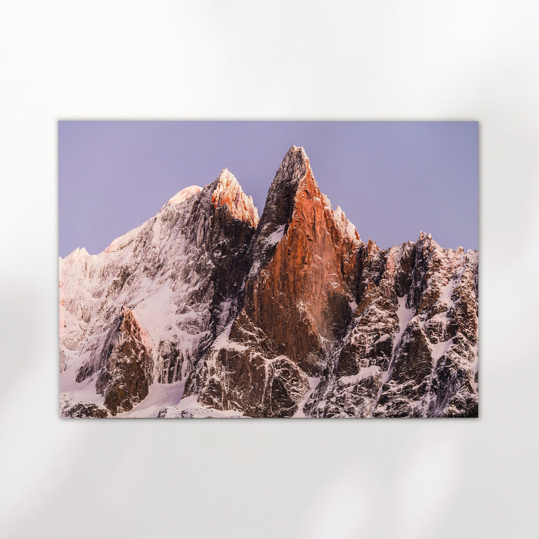 Chamonix wall art print featuring the dramatic twin peaks of Les Drus catching soft alpine light in the French Alps.