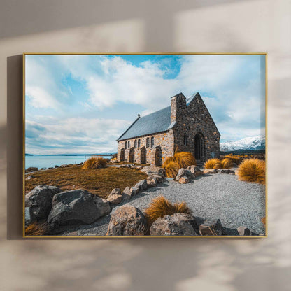 Framed Church of the Good Shepherd Lake Tekapo photography print in gold float frame mounted on warm beige wall with window light shadows