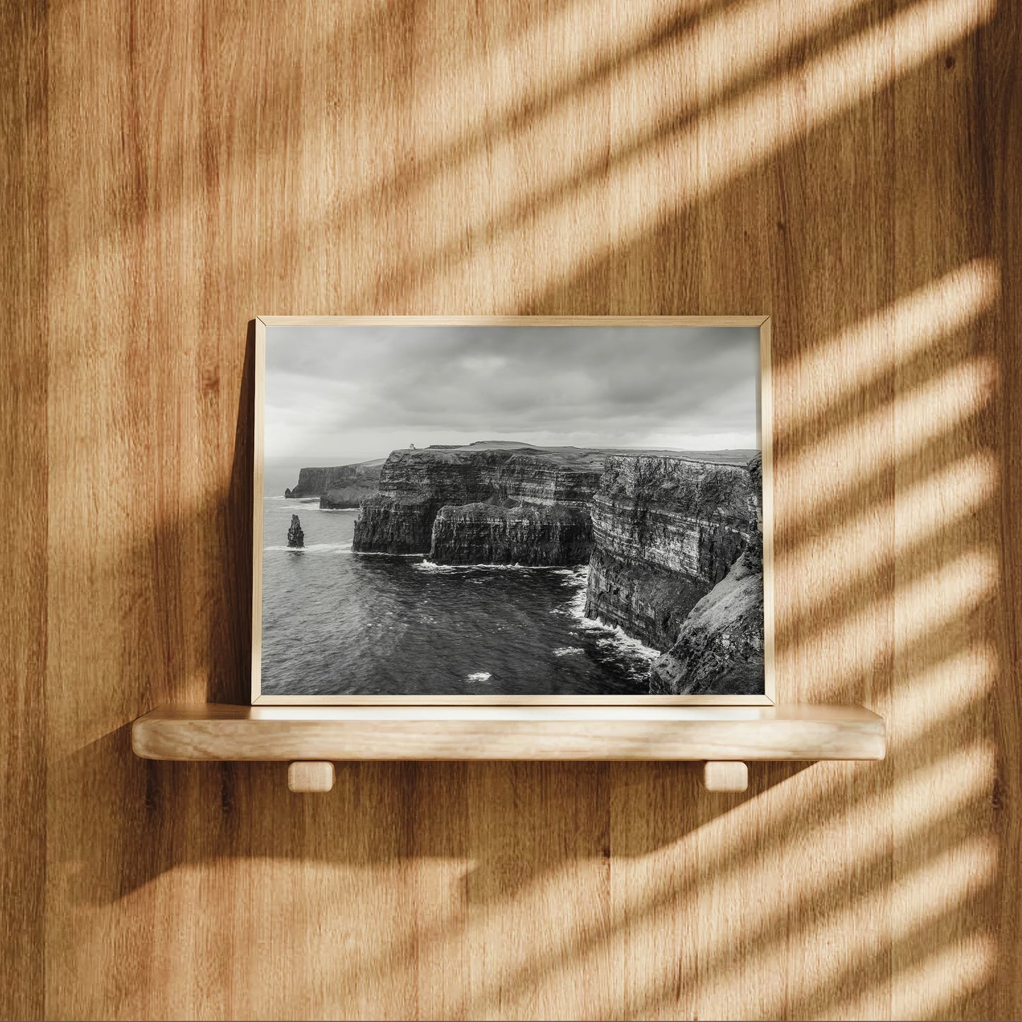 Cliffs of Moher photography displayed on a wooden shelf