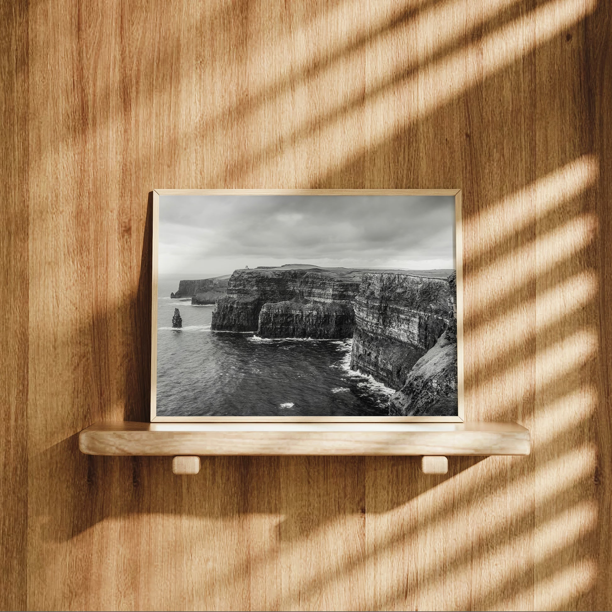 Cliffs of Moher photography displayed on a wooden shelf