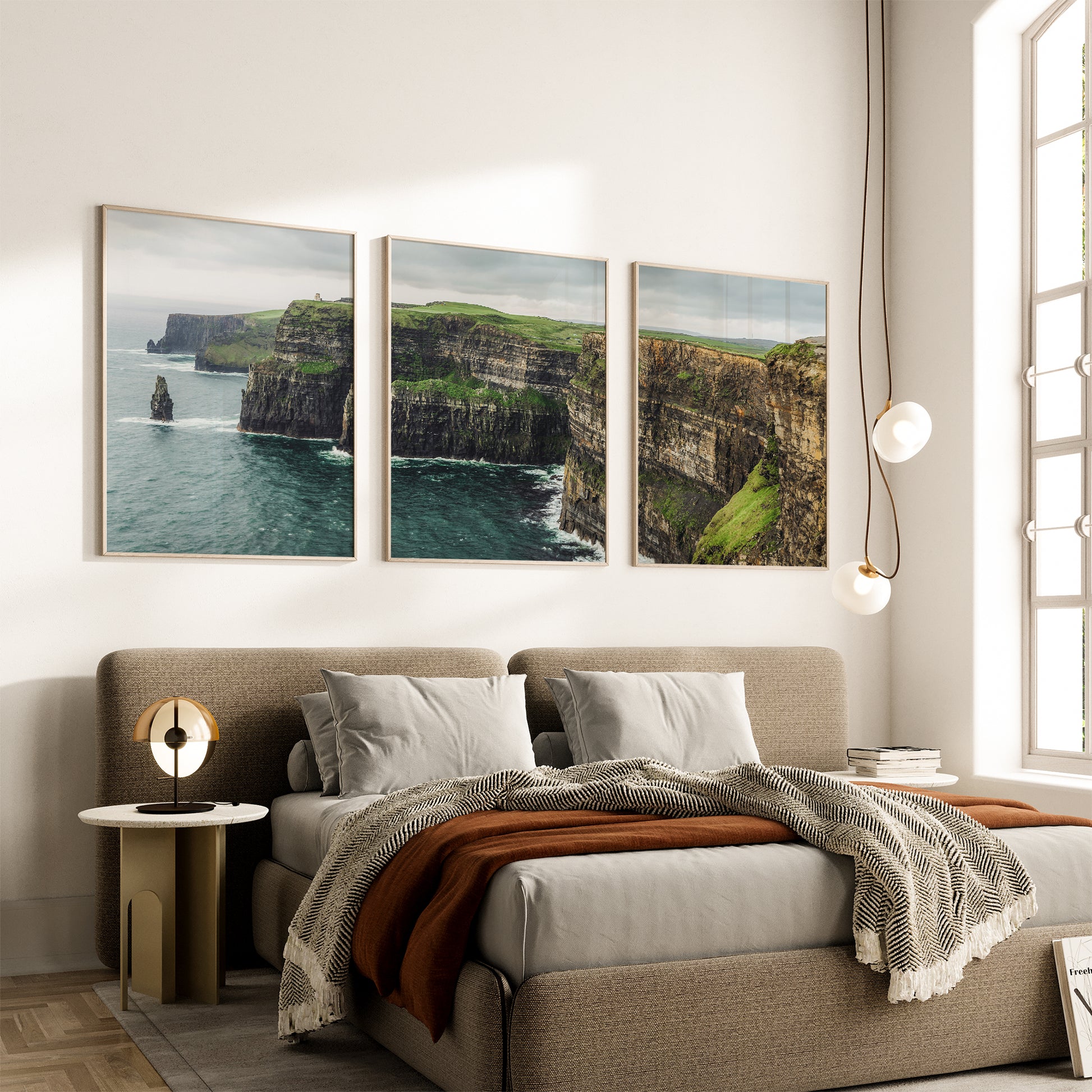 Cliffs of Moher three-piece wall art above neutral bed setup in modern bedroom