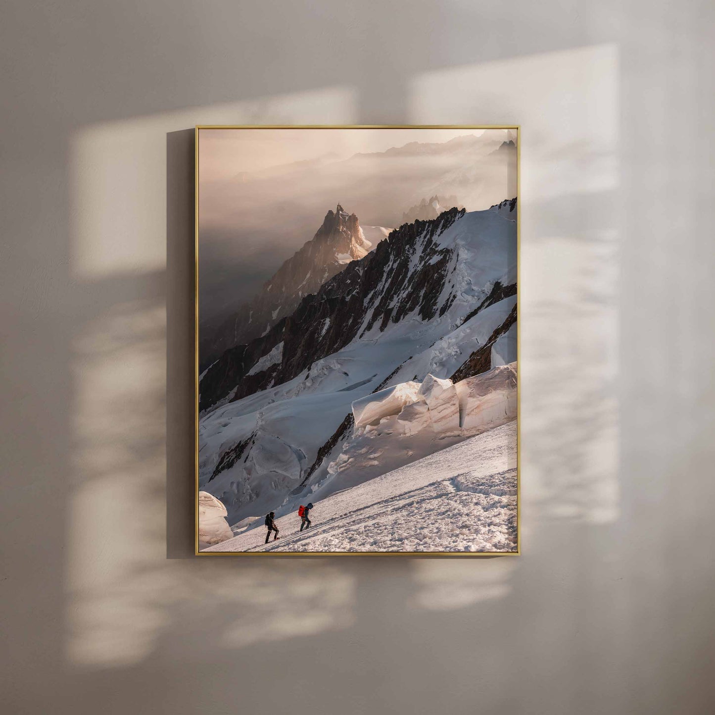 Two climbers ascending Mont Blanc with breathtaking glacial ridges in the distance.