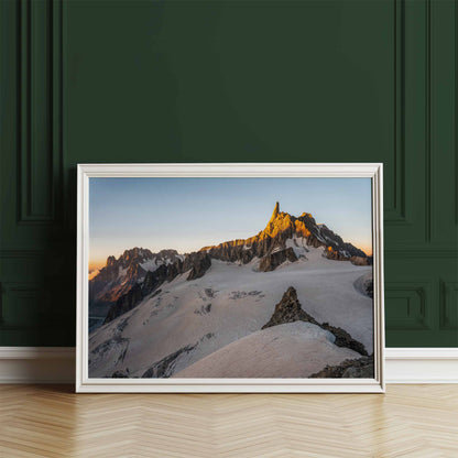 Dent du Géant mountain at golden hour, elegantly framed and leaning against a green wall.