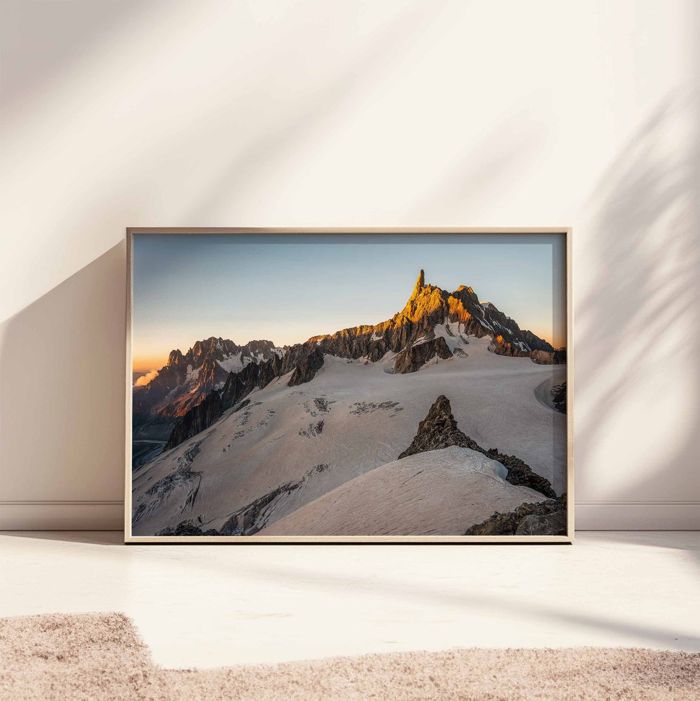 Large framed Dent du Géant photography print displayed on the floor with natural light.