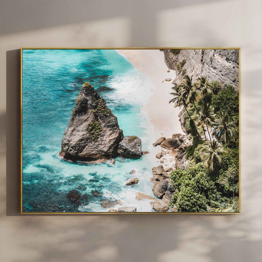 Diamond Beach Nusa Penida landscape aerial wall art print with turquoise water and rock stack in gold floating frame mounted on beige wall