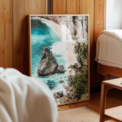 Diamond Beach Nusa Penida aerial framed photography print leaning against wooden wall in cosy bedroom interior