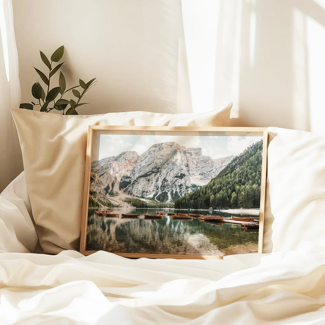Tranquil boat scene on Lago di Braies in the Dolomites, beautifully captured as wall decor with mountain reflections.