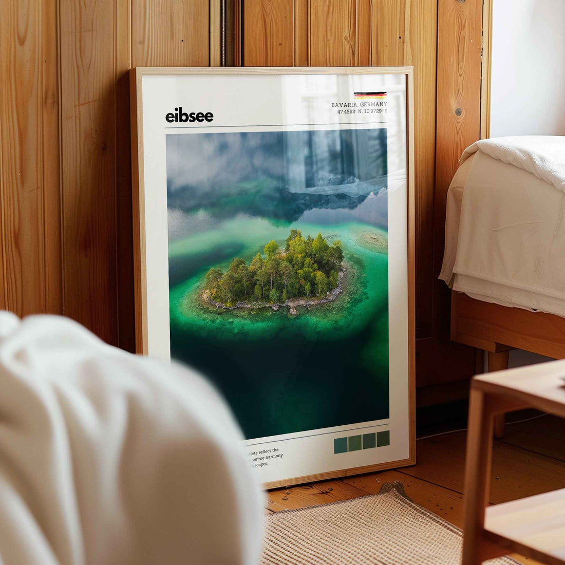 Framed Eibsee aerial island Bavaria Germany print in natural wood frame leaning against pine panelled bedroom wall
