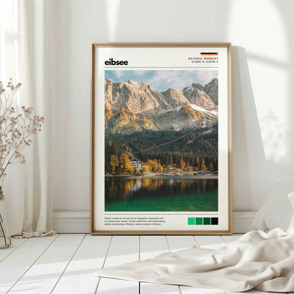 Natural wood framed Eibsee autumn Zugspitze Bavaria Germany print leaning against white wall on white floorboards in minimal Scandinavian interior