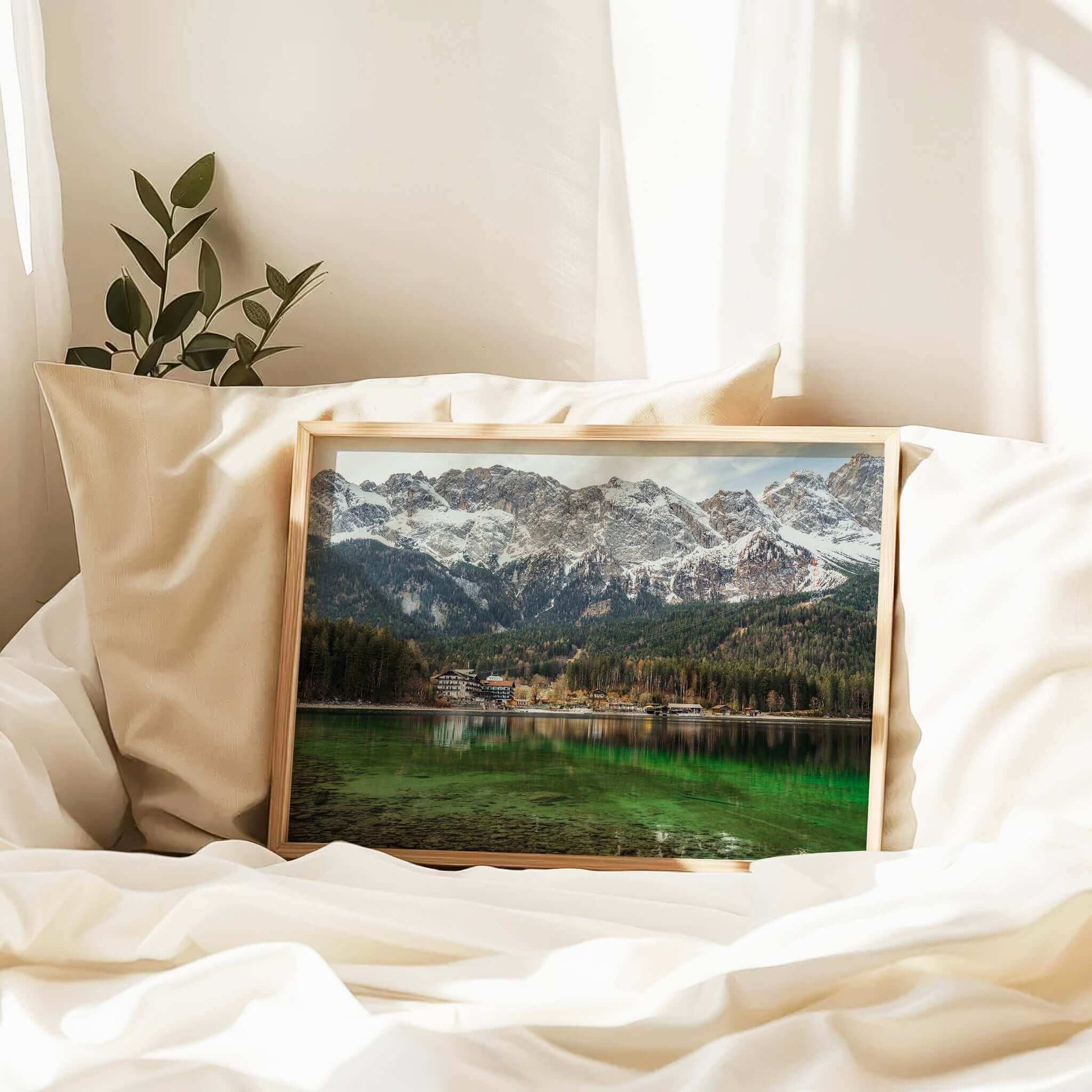 Eibsee Bavaria print resting on white bedding with warm light
