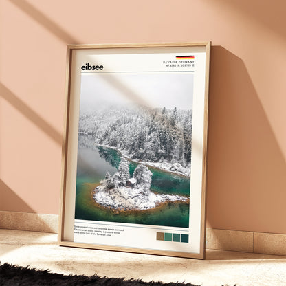 Eibsee winter island cabin Bavaria Germany aerial photography print in natural wood frame leaning against warm terracotta wall on textured floor