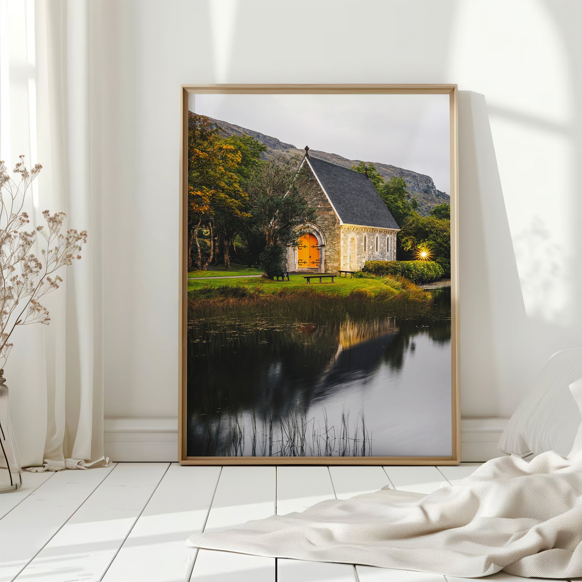 Bright Irish chapel wall print with golden reflections by the lake