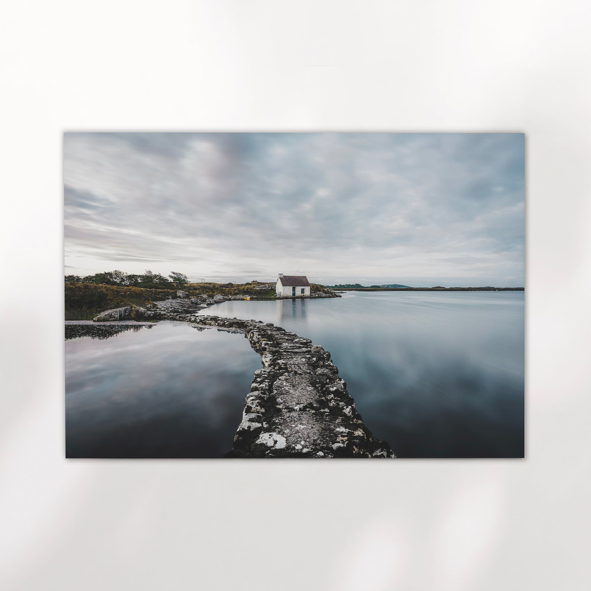 Fine art print of a white bothy and stone path on calm Irish water.