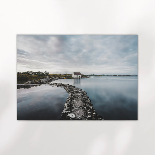 Fine art print of a white bothy and stone path on calm Irish water.
