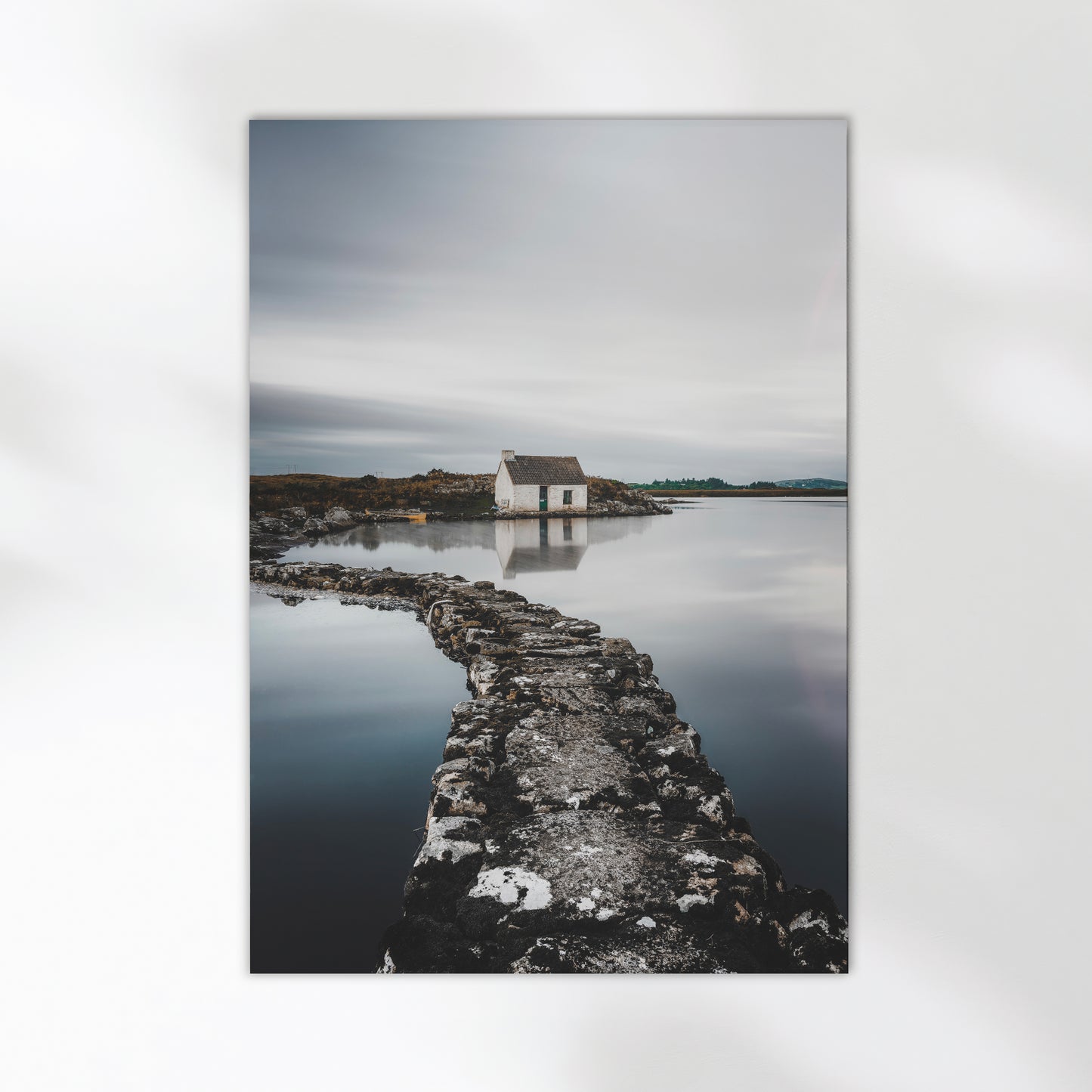 Irish landscape with a stone path leading to a small white bothy