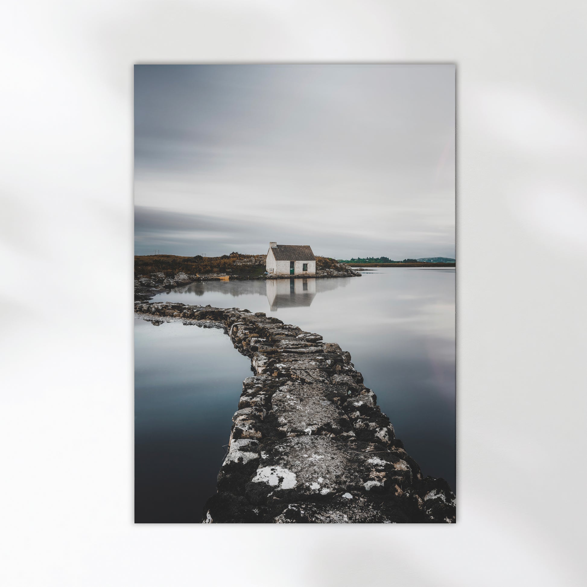 Irish landscape with a stone path leading to a small white bothy