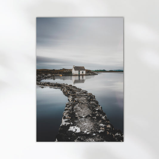 Irish landscape with a stone path leading to a small white bothy