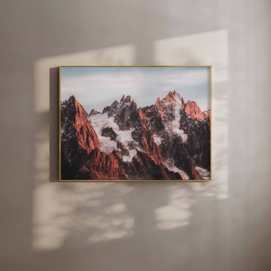 Framed wall art featuring the Aiguilles Rouges glowing red during sunset.