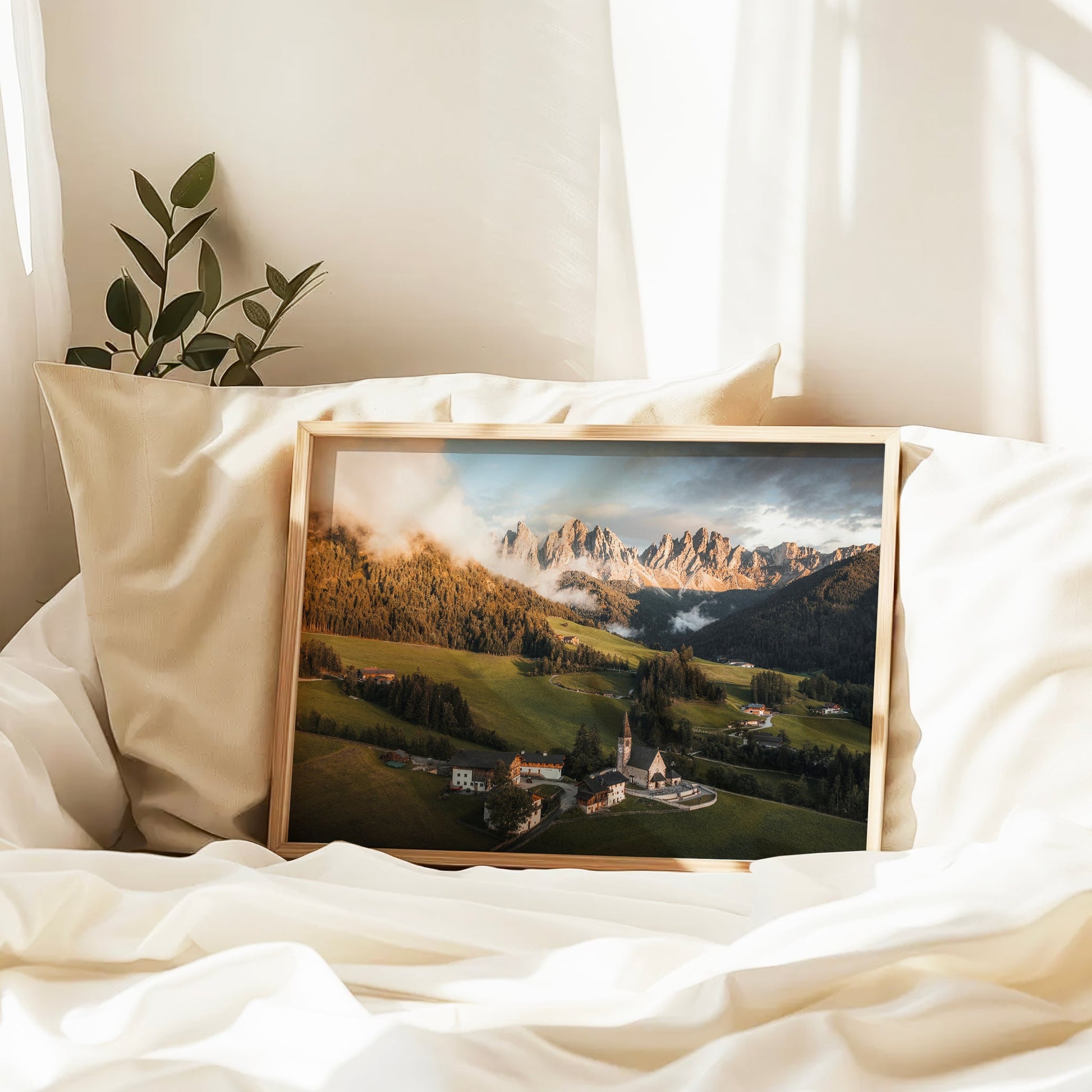St. Magdalena framed print resting on bed in soft morning light