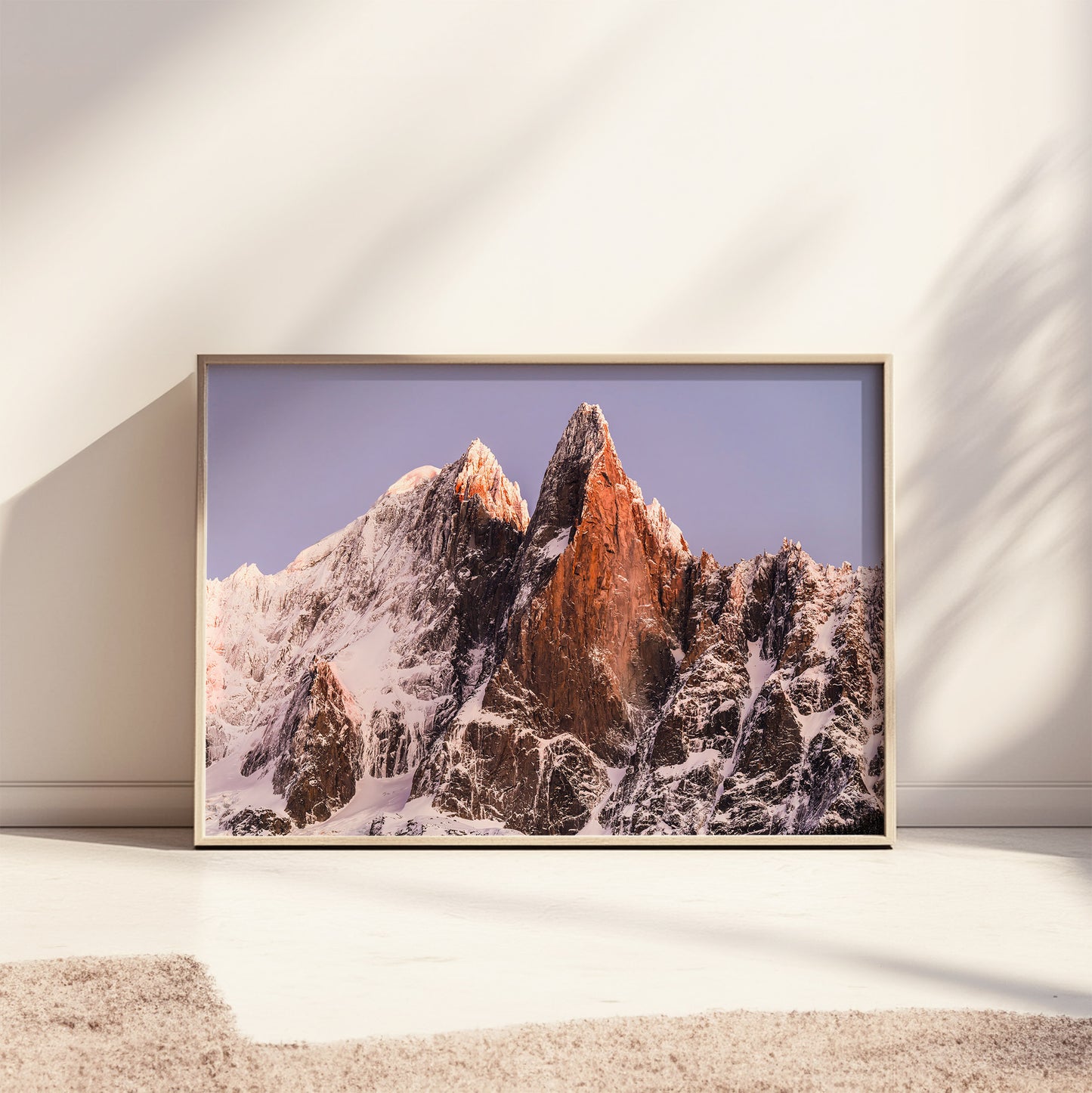 Les Drus wall art print displayed in a neutral modern interior with golden sunlight on the peaks.