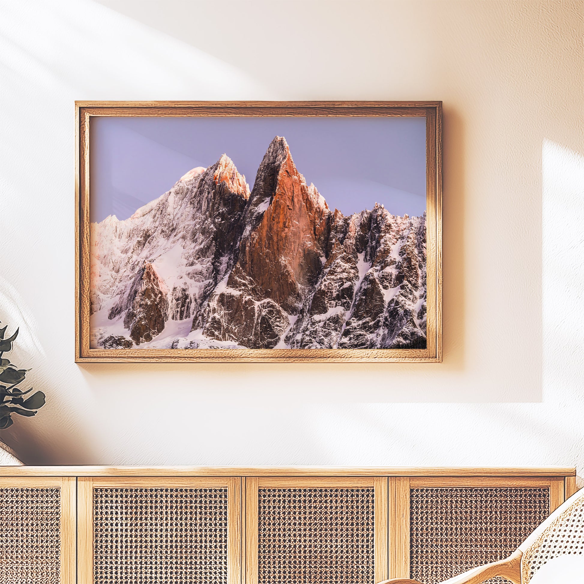 Chamonix mountain decor of Les Drus summit in golden sunrise tones framed in a cozy room setting.