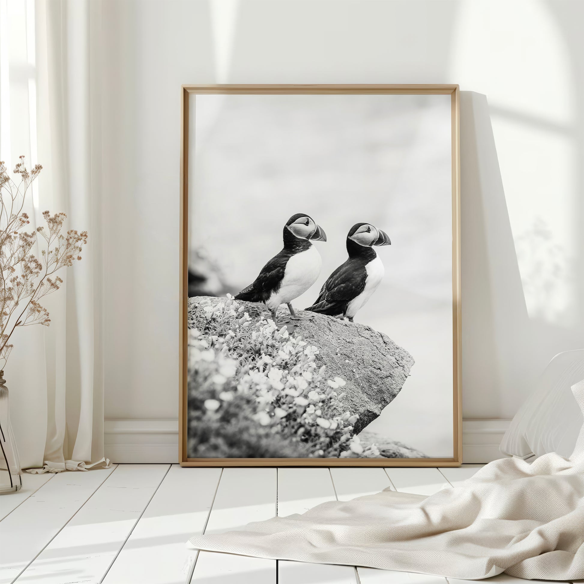 Puffin wall art in bright white room with natural light and curtain.