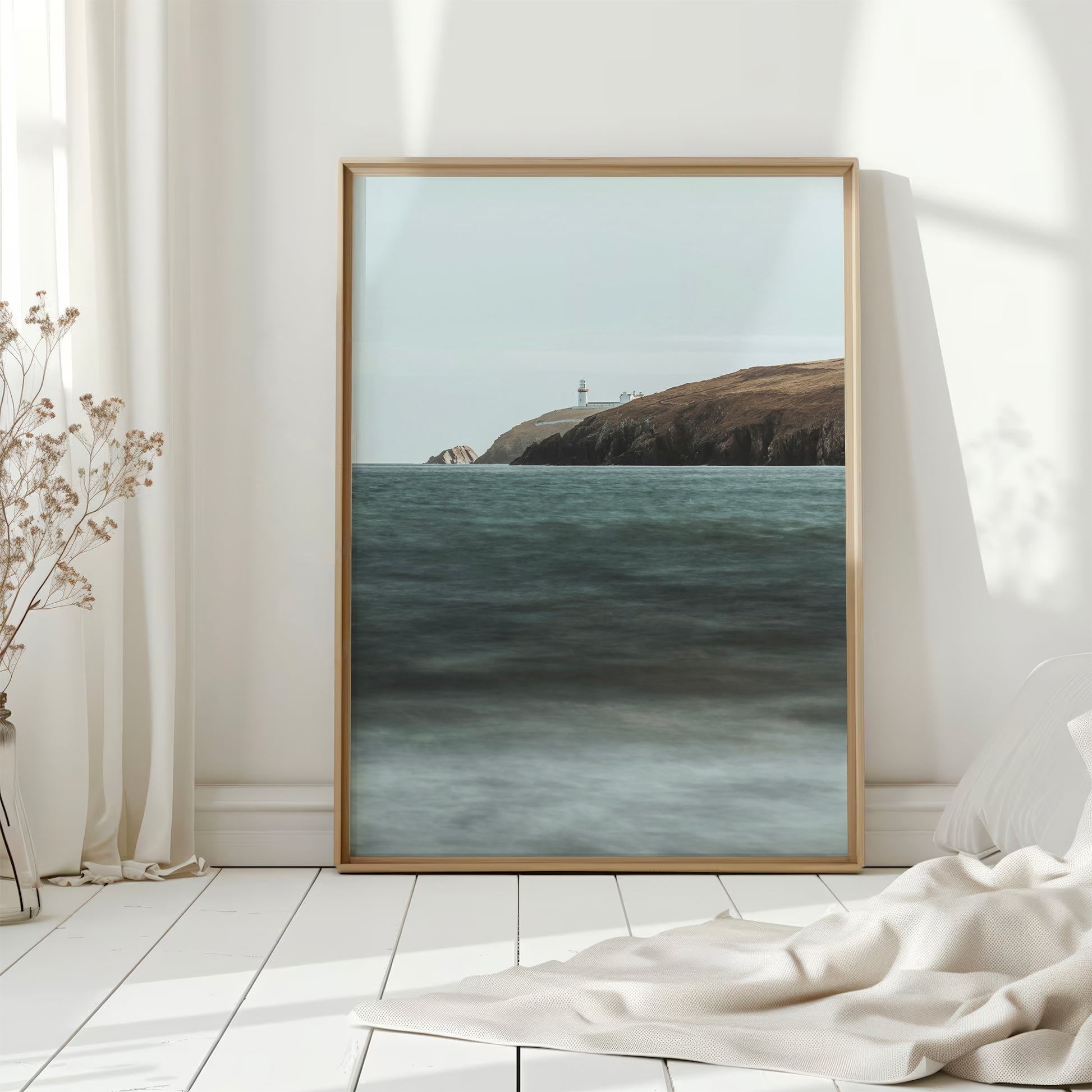 Framed Galley Head Lighthouse art displayed in light-filled white room
