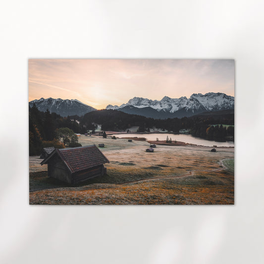 Sunset light over Geroldsee lake with reflections and distant peaks in Germany