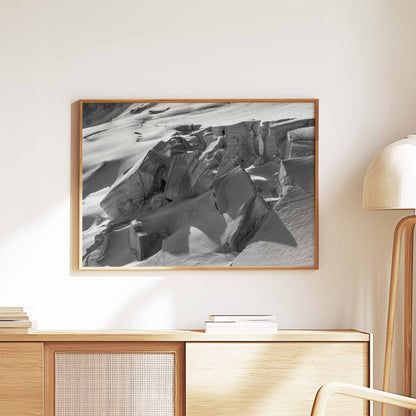 Framed print of Glacier de Taconnez in a light wood frame on a sideboard with modern decor.