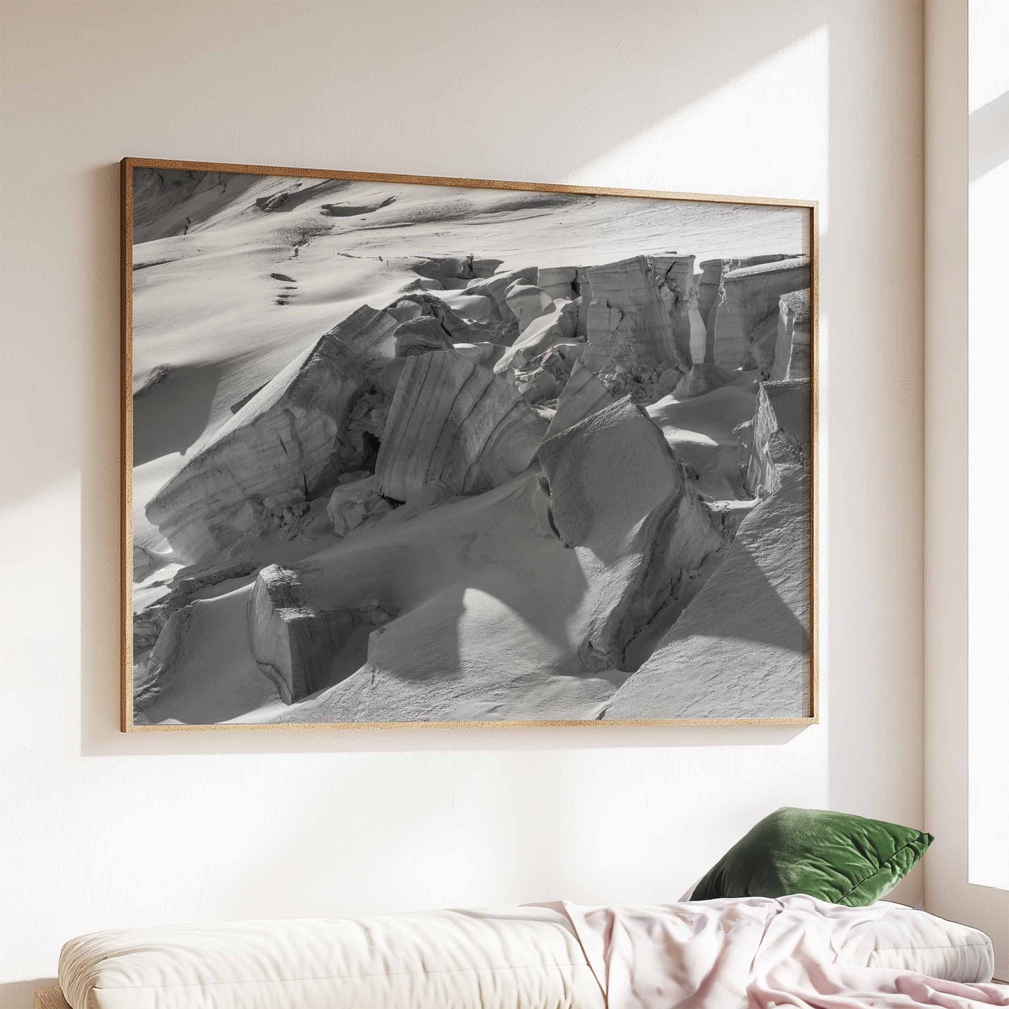 Framed print of Glacier de Taconnez in a natural wood frame above a sofa.