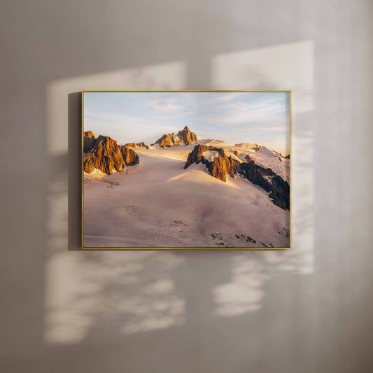 Golden glow of the Aiguille du Midi at sunset with rugged alpine terrain, perfect for a wall art print.