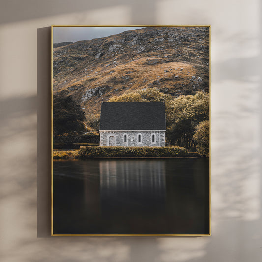 Framed wall art print of Gougane Barra chapel by a lake with mountain backdrop