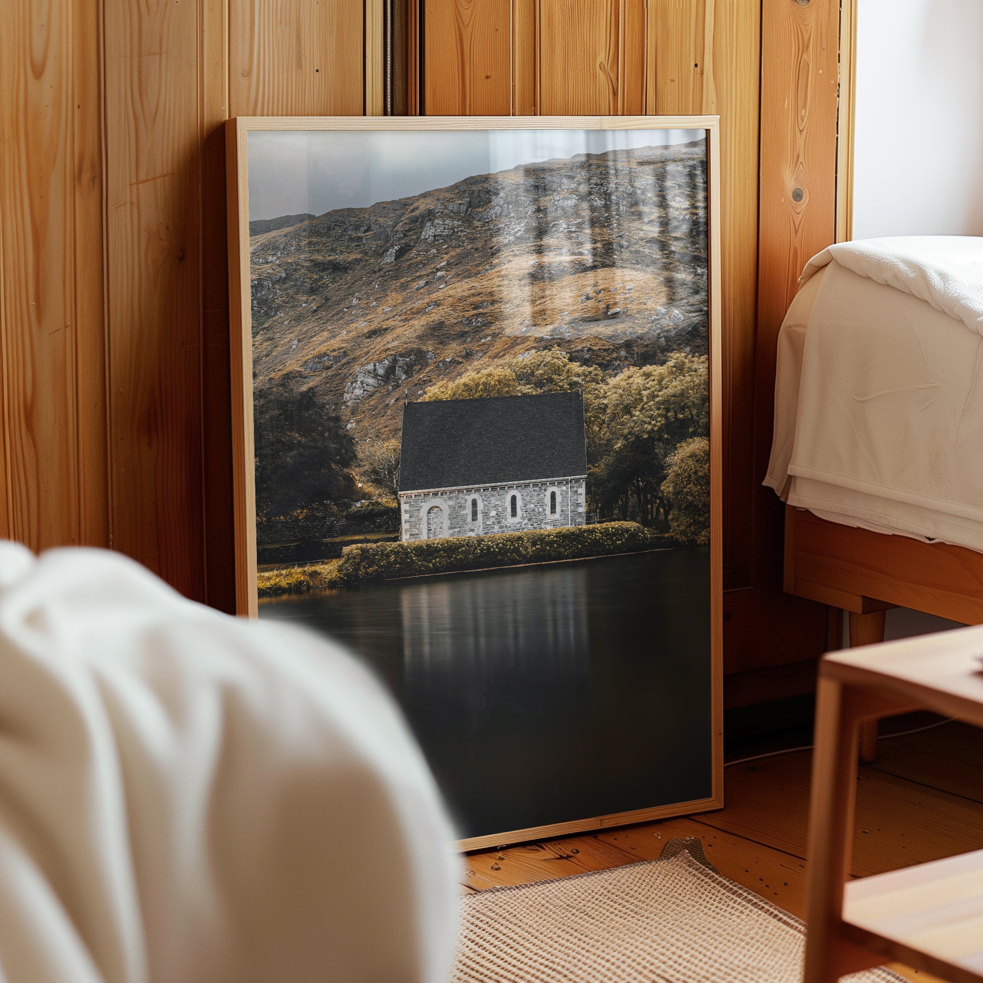 Moody interior with framed print of Irish chapel and lake at Gougane Barra