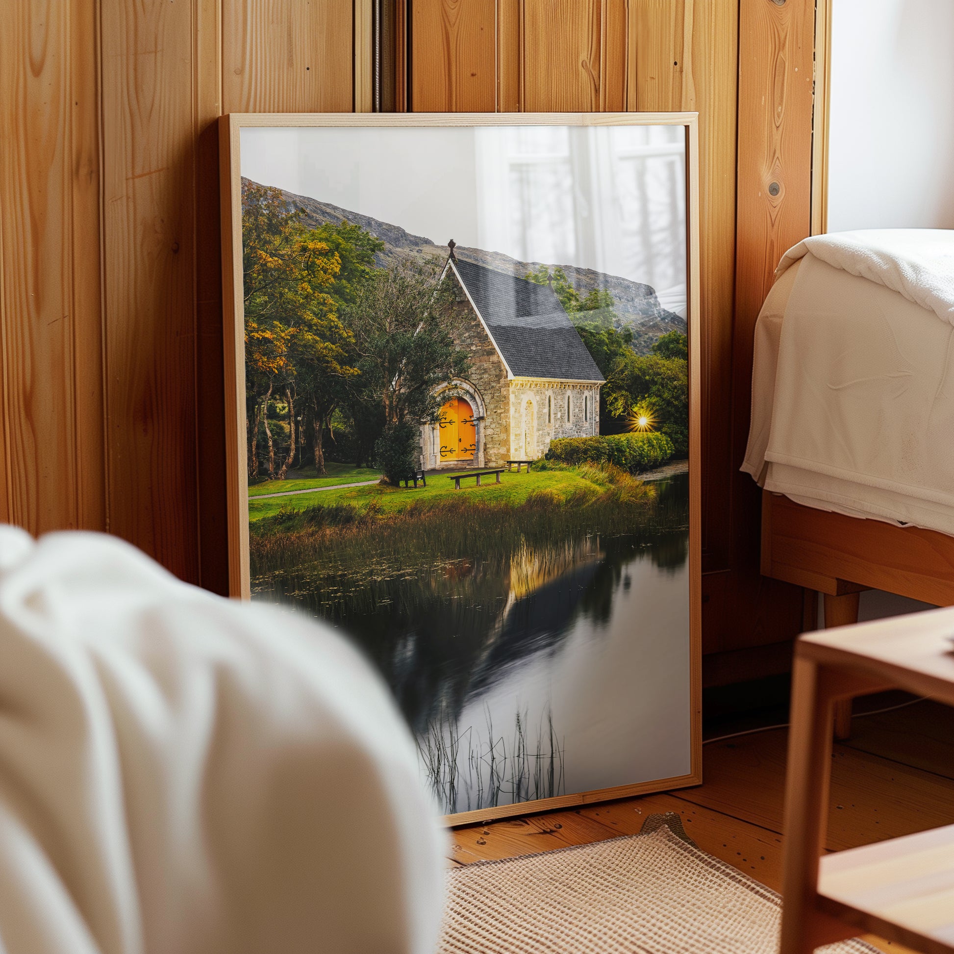 Gougane Barra framed print leaning in a wooden cabin-style bedroom