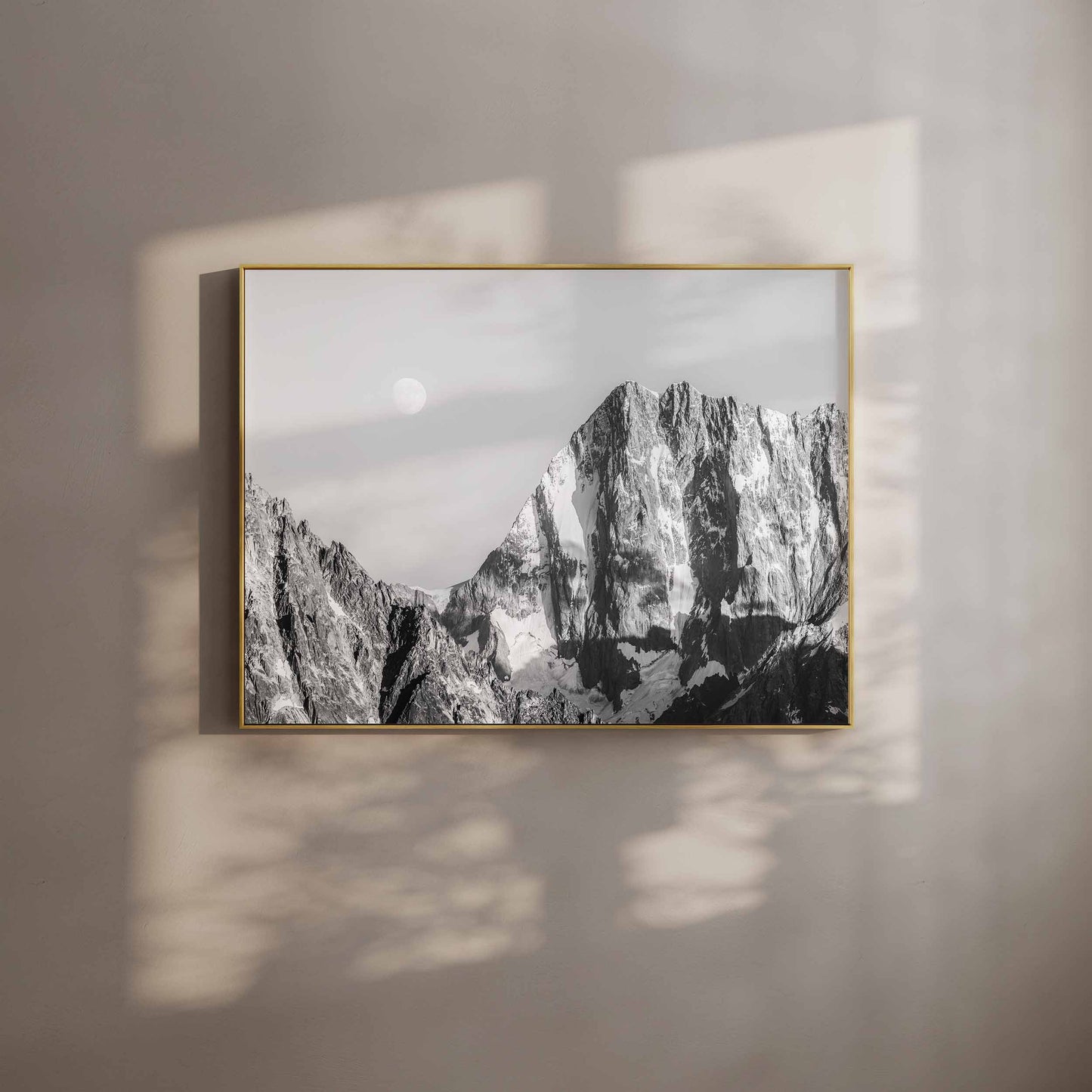 Framed black and white wall art of the Grand Jorasses mountain in soft shadow light.