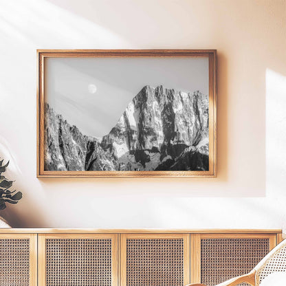 Framed monochrome print of the Grand Jorasses mountain on a stylish wicker cabinet