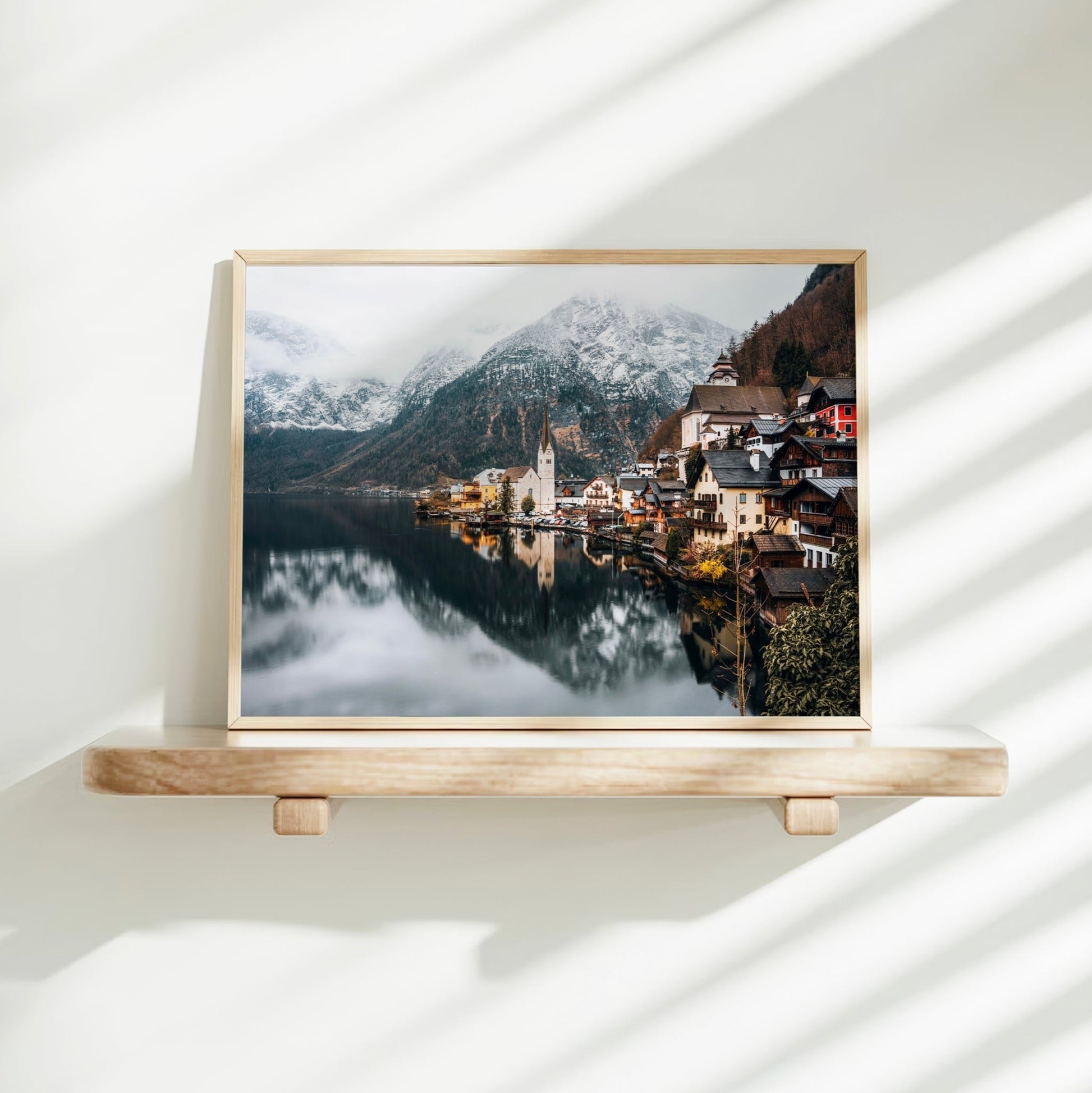 Minimalist Hallstatt landscape print displayed on a floating shelf with shadow lines.