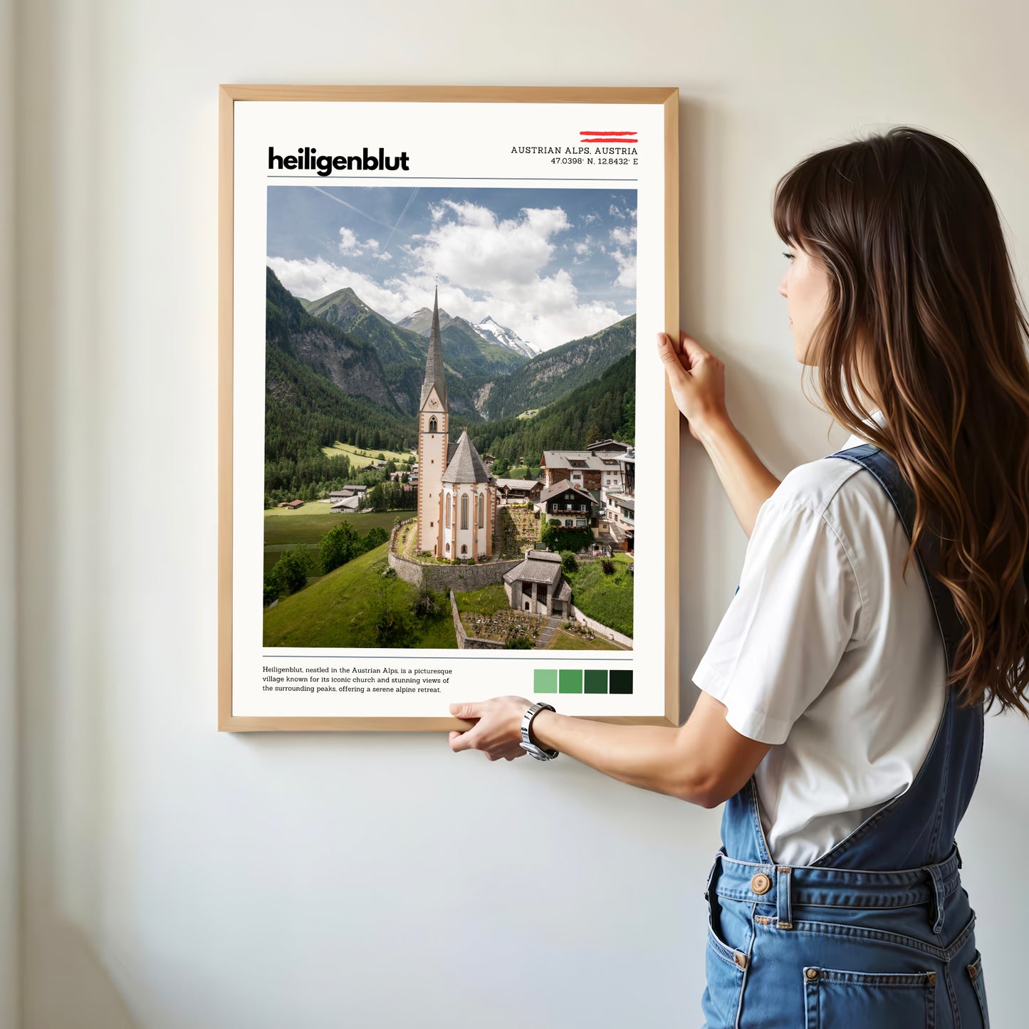 Person hanging a Heiligenblut Austrian Alps location poster in a modern home interior