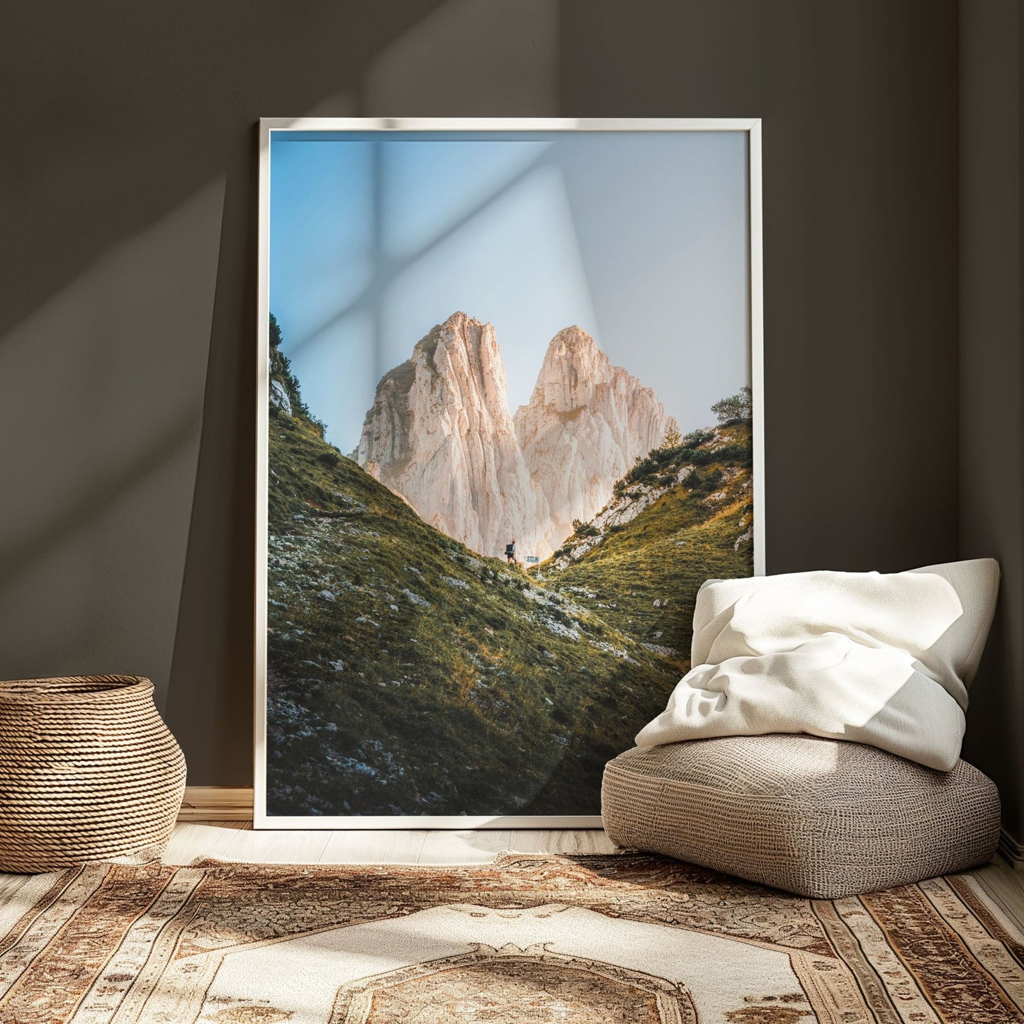 Framed photo of Saxer Lücke featuring a hiker and Swiss Alps' natural beauty, in a modern, softly lit room.