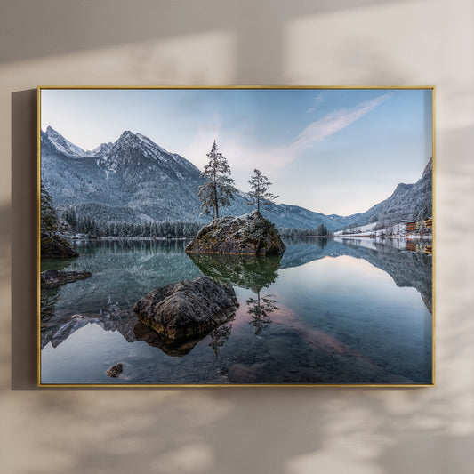 Golden sunrise over Hintersee lake with glowing mountains and reflections