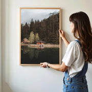Woman holding Mittersee lake wall print featuring forest reflections in Austria