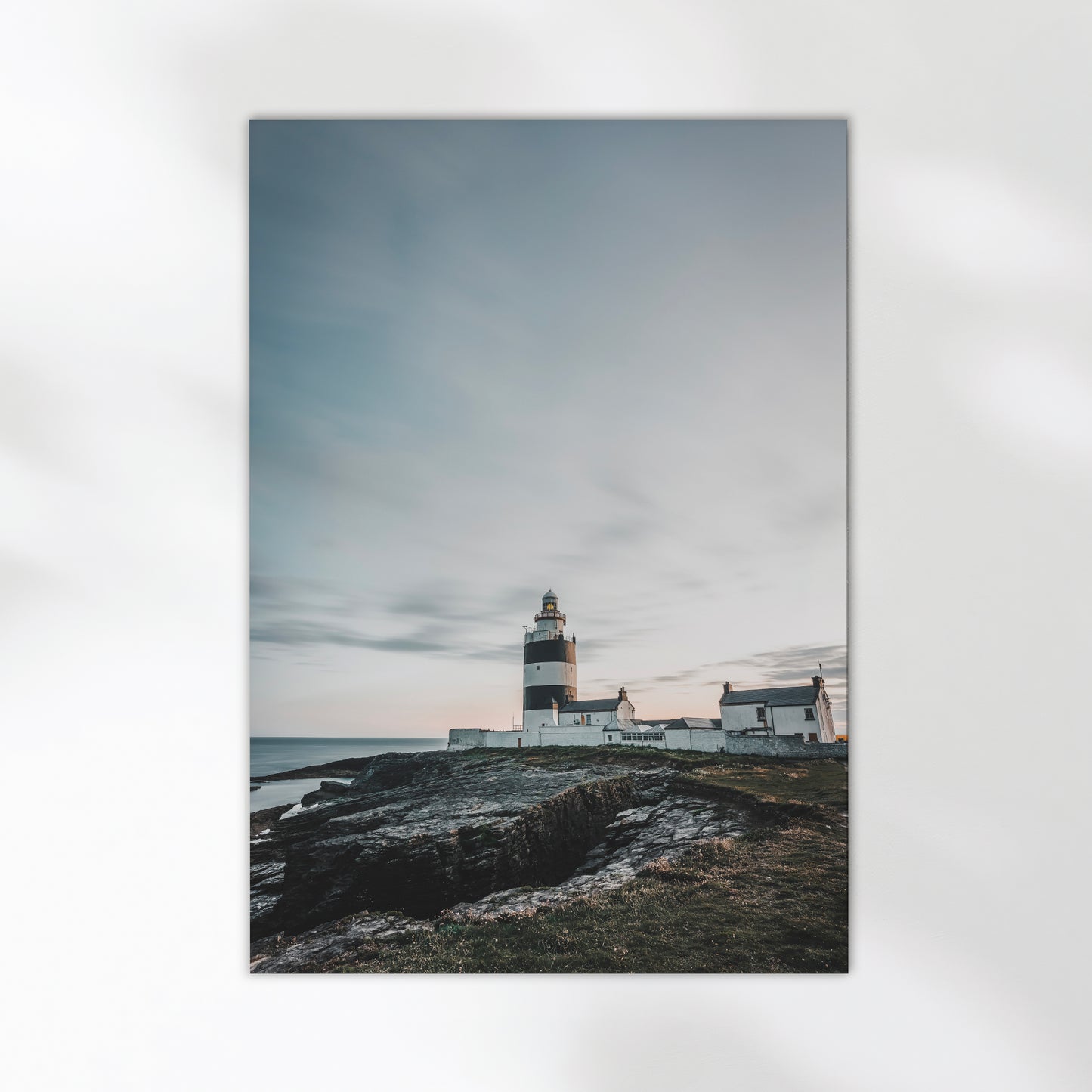 Long exposure photo of Hook Head Lighthouse at sunset with ocean view