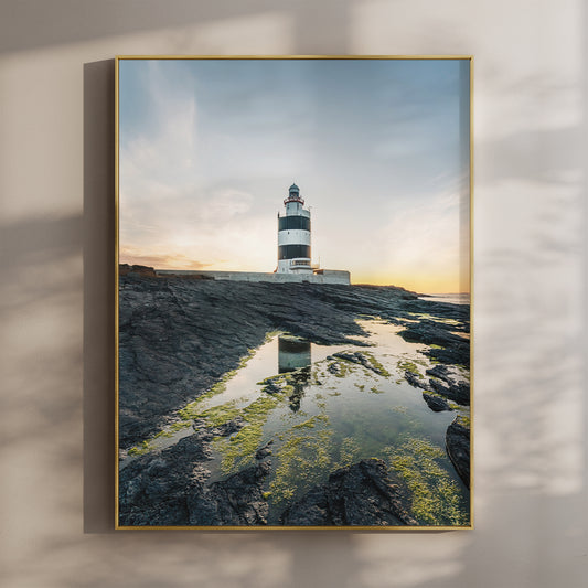 Hook Head Lighthouse at sunset with soft blue sky and golden light, coastal Irish wall art print