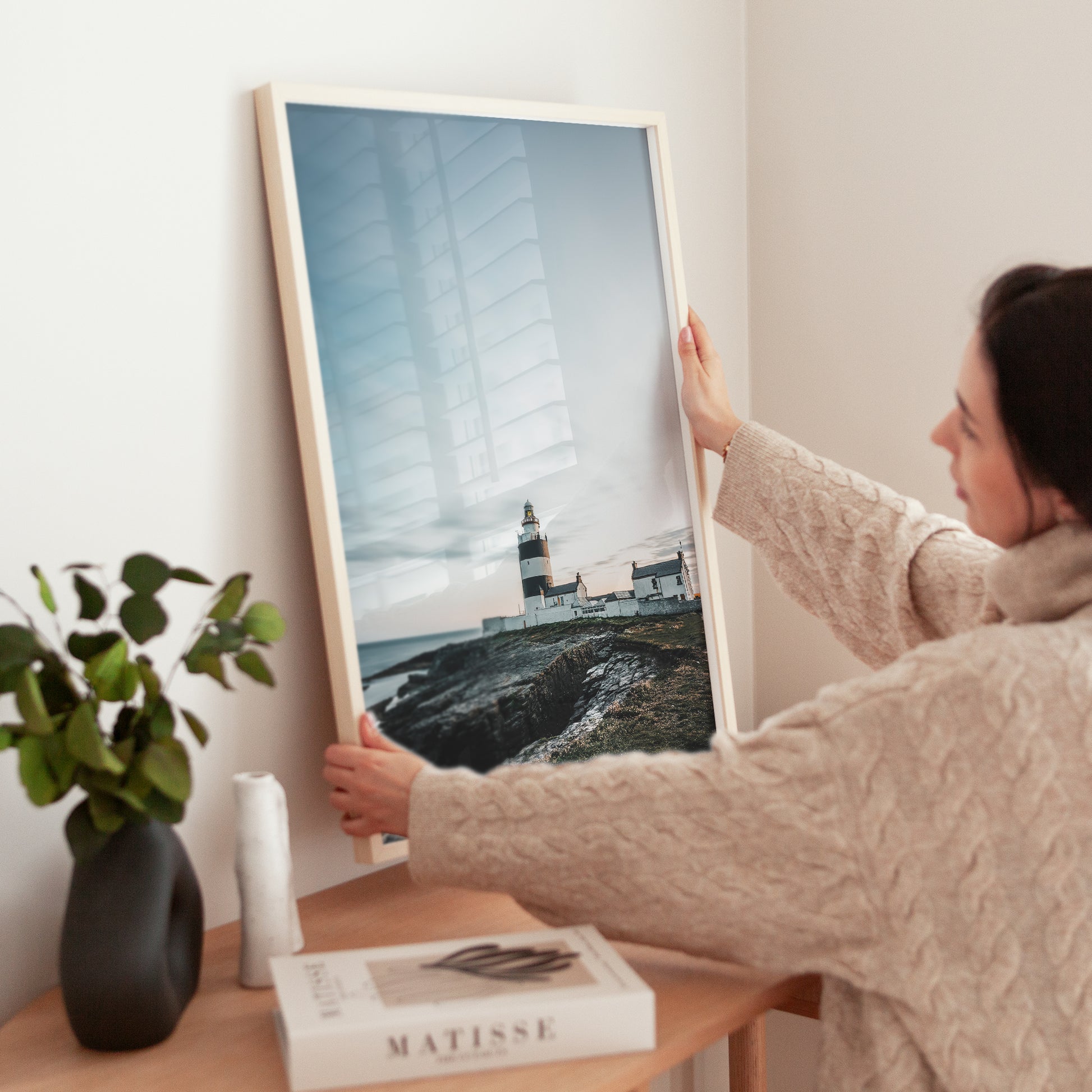 Hook Head Lighthouse fine art print being held by woman indoors