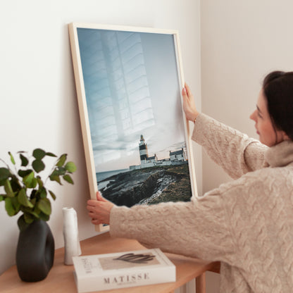 Hook Head Lighthouse fine art print being held by woman indoors