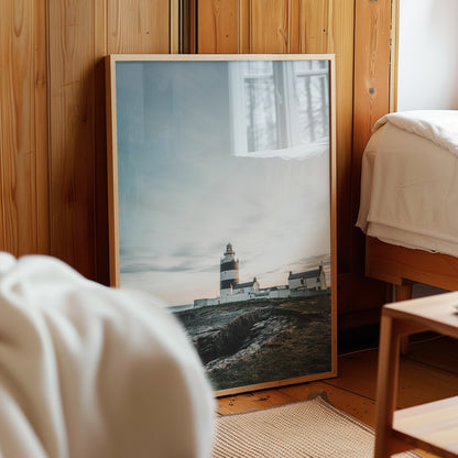 Hook Head Lighthouse framed artwork resting on wooden floor by bed